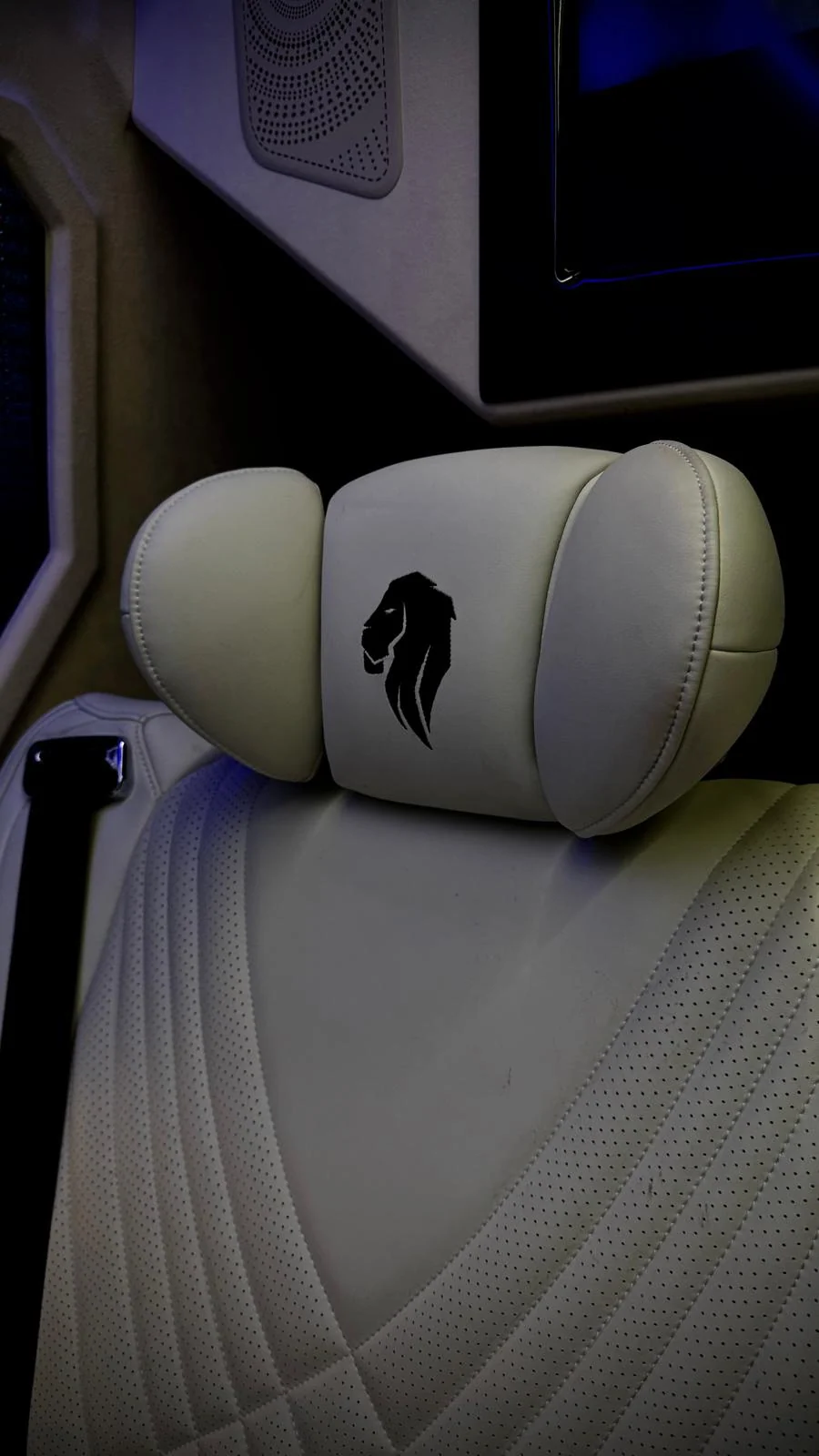 V-Protect lion embroidered in a white leather headrest