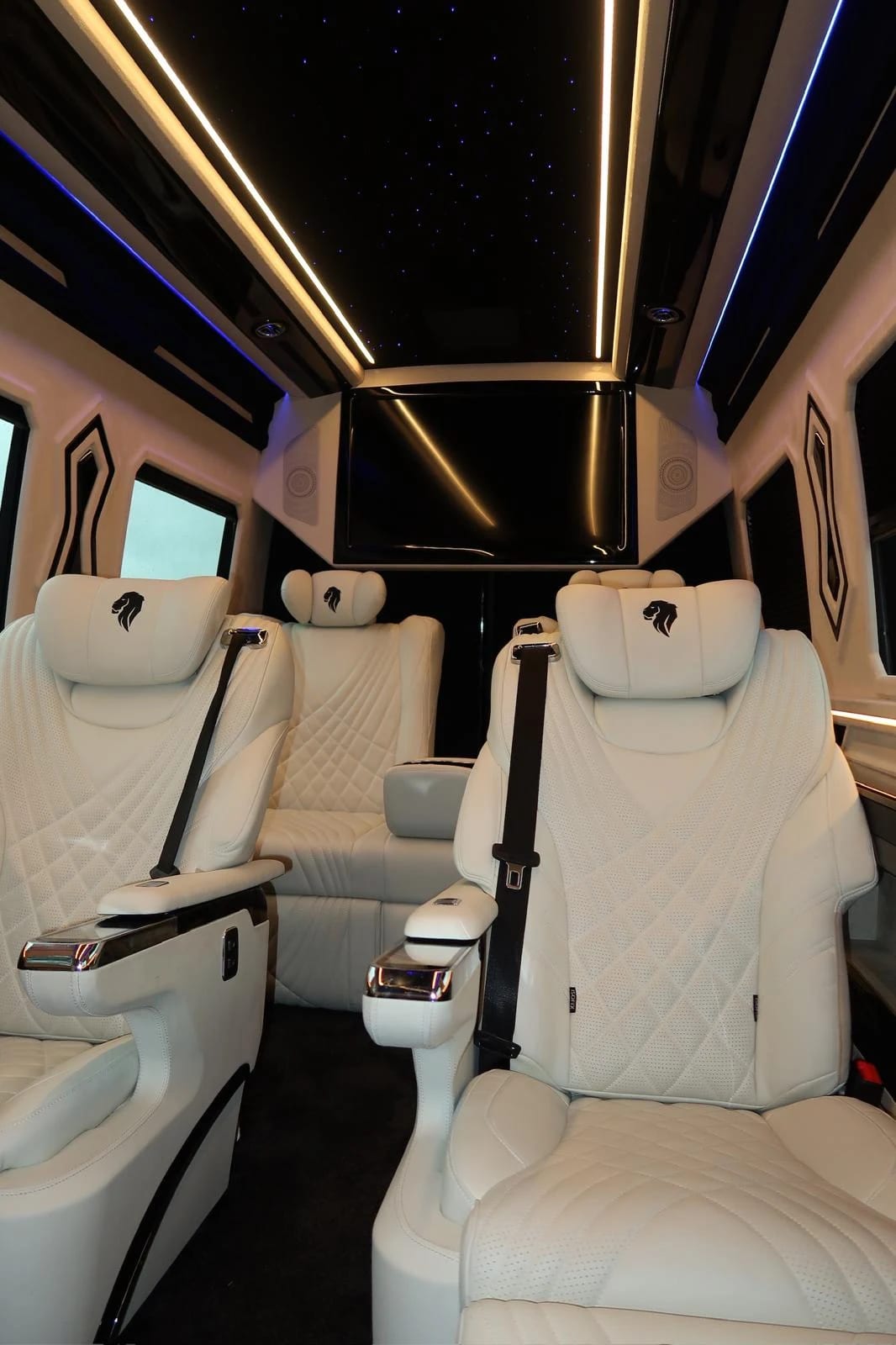 White captain seats beneath a warm-lit starlight ceiling