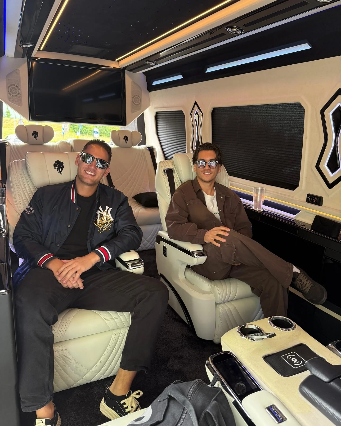 Two guests in white captain chairs with warm ambient lighting